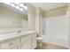 Bathroom featuring a white vanity, toilet, and shower/tub combo with white tiling at 9856 Commonwealth Dr, Fishers, IN 46038