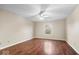 Spacious bedroom featuring a ceiling fan, window with natural light, and beautiful hardwood flooring at 9856 Commonwealth Dr, Fishers, IN 46038
