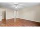 Well-lit bedroom featuring beautiful hardwood flooring, a ceiling fan and closet entrance at 9856 Commonwealth Dr, Fishers, IN 46038