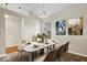 Well-lit dining area featuring a marble table set with seating for six and neutral colored walls at 9856 Commonwealth Dr, Fishers, IN 46038