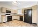 Well-lit kitchen showcasing stainless steel appliances and neutral colored cabinetry at 9856 Commonwealth Dr, Fishers, IN 46038