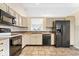 Classic kitchen showcasing ample cabinetry, and stainless steel appliances at 9856 Commonwealth Dr, Fishers, IN 46038