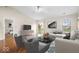 Bright living room featuring hardwood floors, neutral walls, vaulted ceilings, and modern furnishings at 9856 Commonwealth Dr, Fishers, IN 46038