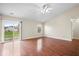 Bright living room featuring hardwood floors, neutral walls, with sliding glass door and a window view of the yard at 9856 Commonwealth Dr, Fishers, IN 46038