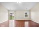 Bright living room featuring hardwood floors, neutral walls, with sliding glass door and a window view of the yard at 9856 Commonwealth Dr, Fishers, IN 46038