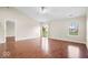 Spacious living room featuring hardwood floors, neutral walls, vaulted ceilings, and natural lighting at 9856 Commonwealth Dr, Fishers, IN 46038