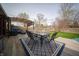 Backyard deck with outdoor dining set on a stylish rug overlooking the lawn and flowering tree at 1019 N Lesley Ave, Indianapolis, IN 46219