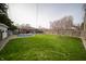 Spacious backyard with lush green grass, above-ground pool, deck, and blossoming tree at 1019 N Lesley Ave, Indianapolis, IN 46219