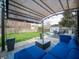 Covered patio featuring comfortable seating, coffee table, and view of grassy backyard with above-ground pool at 1019 N Lesley Ave, Indianapolis, IN 46219