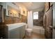 Bathroom featuring shower over tub, brown tiled accent wall, and stylish vanity at 1019 N Lesley Ave, Indianapolis, IN 46219