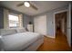 Bedroom with hardwood floors, ceiling fan, and closet at 1019 N Lesley Ave, Indianapolis, IN 46219