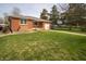 Charming brick home featuring a well-manicured lawn and an attached garage with a side view at 1019 N Lesley Ave, Indianapolis, IN 46219