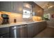 Close-up on kitchen showing countertops, cabinets, stainless steel dishwasher, backsplash, and decor at 1019 N Lesley Ave, Indianapolis, IN 46219