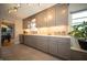 Spacious kitchen featuring gray cabinets, stainless steel appliances, white countertops, and an eat-in dining space at 1019 N Lesley Ave, Indianapolis, IN 46219