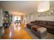 Open-concept living space with hardwood floors, comfortable sofa, and dining area bathed in natural light at 1019 N Lesley Ave, Indianapolis, IN 46219