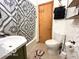 Cozy bathroom featuring patterned shower curtain, toilet, and white vessel sink at 11522 N 450 W, Alexandria, IN 46001