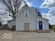 Rear exterior view of a gray home with a gravel lot and entry door at 11522 N 450 W, Alexandria, IN 46001
