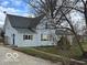 Gray two-story home with a gravel lot and a blue entry door at 11522 N 450 W, Alexandria, IN 46001