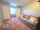 Comfortable living room with a large couch and natural light from the window at 11522 N 450 W, Alexandria, IN 46001