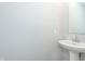 Elegant pedestal sink and mirror create a bright, minimalist bathroom space at 1239 Newton St, Avon, IN 46123