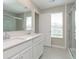 Bathroom featuring double sinks, modern fixtures, and a glass-enclosed shower for a luxurious experience at 1239 Newton St, Avon, IN 46123