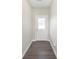 The entry hall is features a sleek gray wood floor and a bright white entry door at 1239 Newton St, Avon, IN 46123