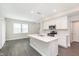 Well-lit kitchen features an island sink, stainless steel appliances, and white cabinets at 1239 Newton St, Avon, IN 46123