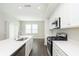 Bright kitchen featuring an island with sink, stainless steel gas stove, and white cabinetry at 1239 Newton St, Avon, IN 46123