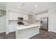 The kitchen features modern stainless steel appliances, an island with a sink, and white cabinets at 1239 Newton St, Avon, IN 46123