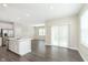 Bright, open-concept floor plan with gray wood floors, neutral walls, and sliding door at 1239 Newton St, Avon, IN 46123