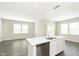 Open floor plan features a gray wood floor, recessed lighting, and bright, neutral walls at 1239 Newton St, Avon, IN 46123