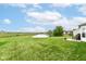 Large backyard with pond, expansive lawn, and patio with outdoor seating at 14060 Princewood Dr, Fishers, IN 46037