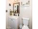Cozy half bath featuring vanity with white cabinetry, a framed mirror, and decorative wall accents at 14060 Princewood Dr, Fishers, IN 46037
