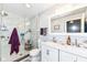 Bathroom featuring a double sink vanity, marble tile shower, and elegant lighting fixtures at 14060 Princewood Dr, Fishers, IN 46037