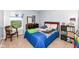 Cozy bedroom with a large window offering views of the backyard, wood furniture, and blue bedding at 14060 Princewood Dr, Fishers, IN 46037