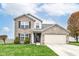 Charming two-story brick home featuring a well-manicured lawn and an attached two-car garage at 14060 Princewood Dr, Fishers, IN 46037