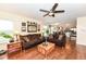 Inviting living room showcasing hardwood floors, a ceiling fan, and open layout to the kitchen at 14060 Princewood Dr, Fishers, IN 46037