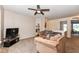 Inviting living room with neutral carpeting, cozy armchairs, and a ceiling fan for added comfort at 14060 Princewood Dr, Fishers, IN 46037