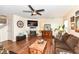 Cozy living room with hardwood floors, a decorative fireplace, and comfortable seating at 14060 Princewood Dr, Fishers, IN 46037