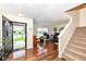 Bright open-concept living area with hardwood floors and a staircase, bathed in natural light at 14060 Princewood Dr, Fishers, IN 46037