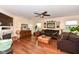 Spacious living room with hardwood floors, fireplace, a ceiling fan, and ample natural light at 14060 Princewood Dr, Fishers, IN 46037