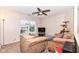 Inviting living room with neutral carpeting, cozy armchairs, and a ceiling fan for added comfort at 14060 Princewood Dr, Fishers, IN 46037