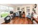 Bright home office with wood floors, blue accent chairs, artwork, and a Litter Robot in the foreground at 14060 Princewood Dr, Fishers, IN 46037