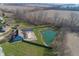 Overhead view of home with large private pond, pool and trampoline, surrounded by greenery at 1471 S Frog Pond Ct, Greenfield, IN 46140
