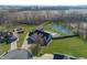 Aerial view of home with private pond, pool, trampoline, and three car garage at 1471 S Frog Pond Ct, Greenfield, IN 46140