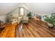 Attic room features natural light, wood floors, seating area, and plants at 1471 S Frog Pond Ct, Greenfield, IN 46140