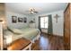 Bright bedroom featuring wood floors, a ceiling fan, and natural light at 1471 S Frog Pond Ct, Greenfield, IN 46140