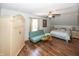 This bedroom is well-lit with wood flooring, a sofa, and a ceiling fan at 1471 S Frog Pond Ct, Greenfield, IN 46140