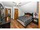 Cozy bedroom with modern bedding, a ceiling fan, and wood flooring at 1471 S Frog Pond Ct, Greenfield, IN 46140