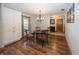 Cozy dining area with wood floors, modern chandelier, and ample storage at 1471 S Frog Pond Ct, Greenfield, IN 46140